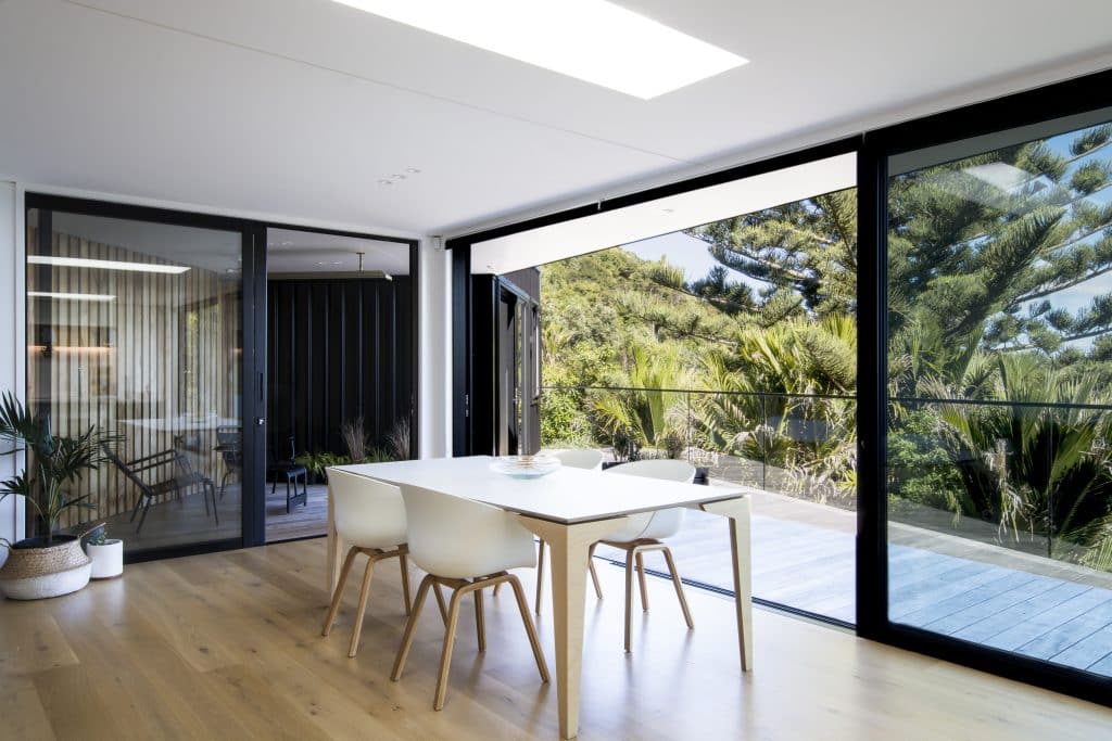 Light wood flooring in open dining area on waiheke