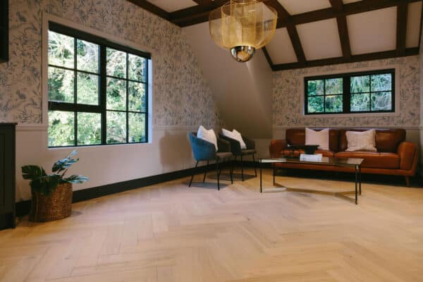 Oak herringbone floor in sun-filled home. Natural light coloured wood floor.