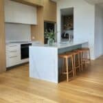 light natural wood flooring in open plan kitchen