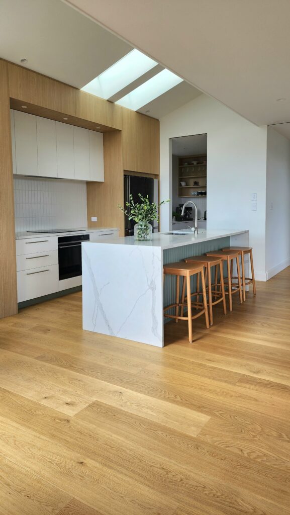 light natural wood flooring in open plan kitchen