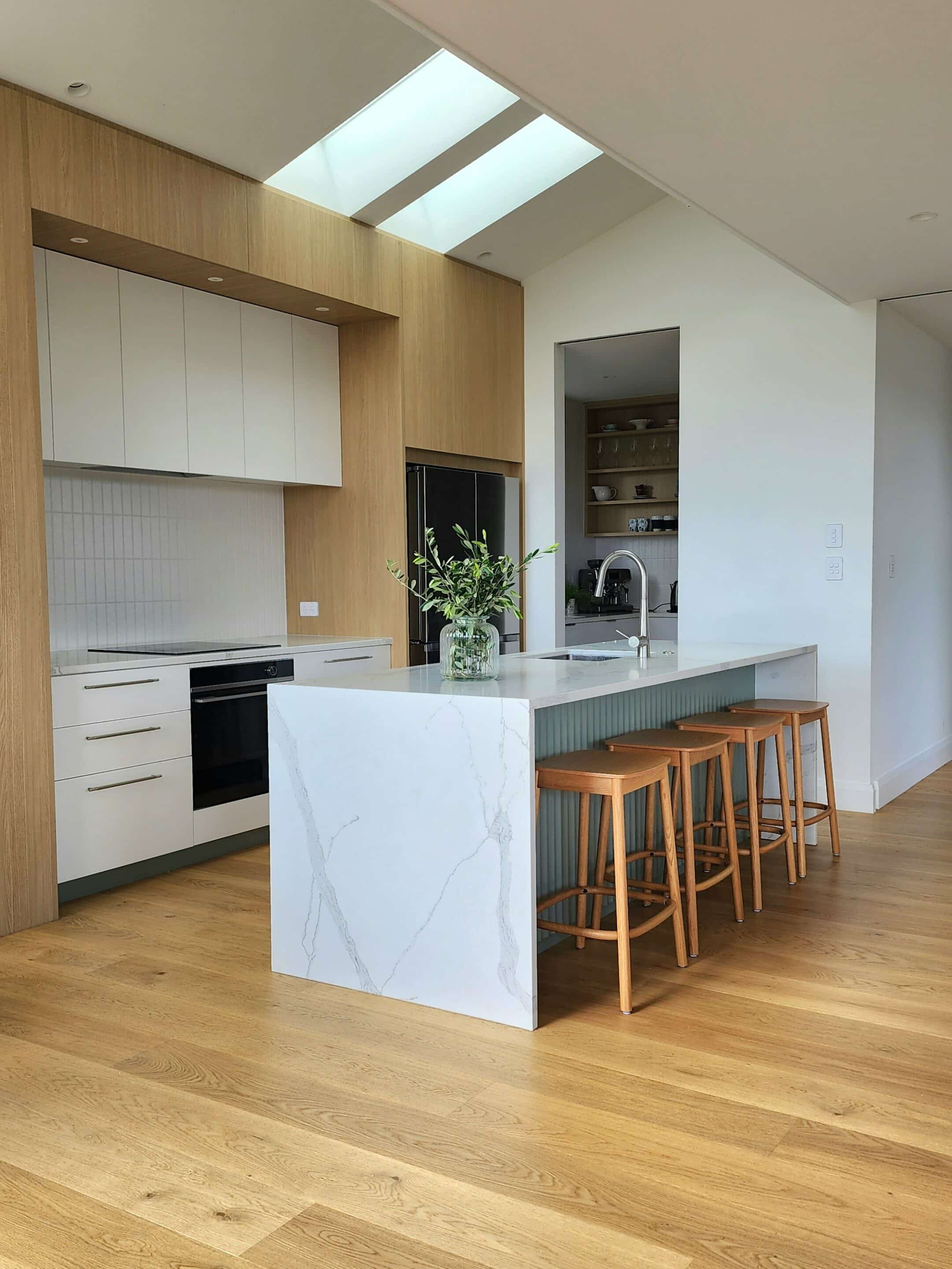 light natural wood flooring in open plan kitchen