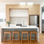 Natural wood floors with light filled kitchen