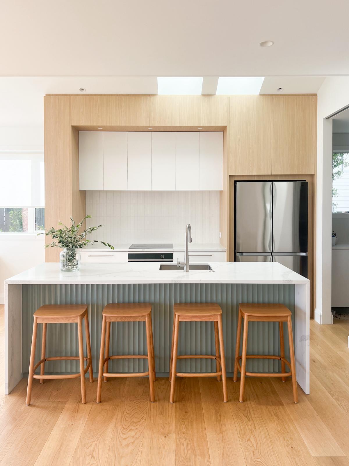 Natural wood floors with light filled kitchen