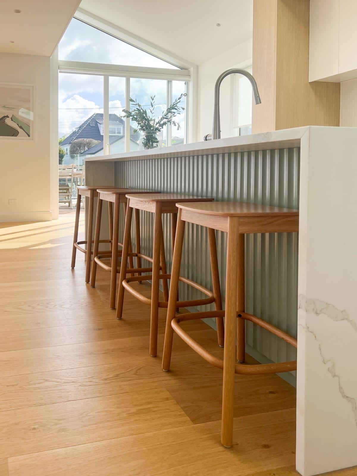 Natural wood floors with light filled kitchen