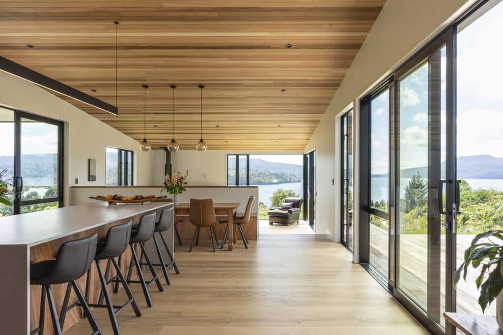 White oak hardwood flooring in open plan living dining with timber ceilings and a view