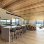 White oak hardwood flooring in open plan living dining with timber ceilings and a view