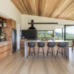 White oak hardwood flooring in open plan living dining with timber ceilings and a view