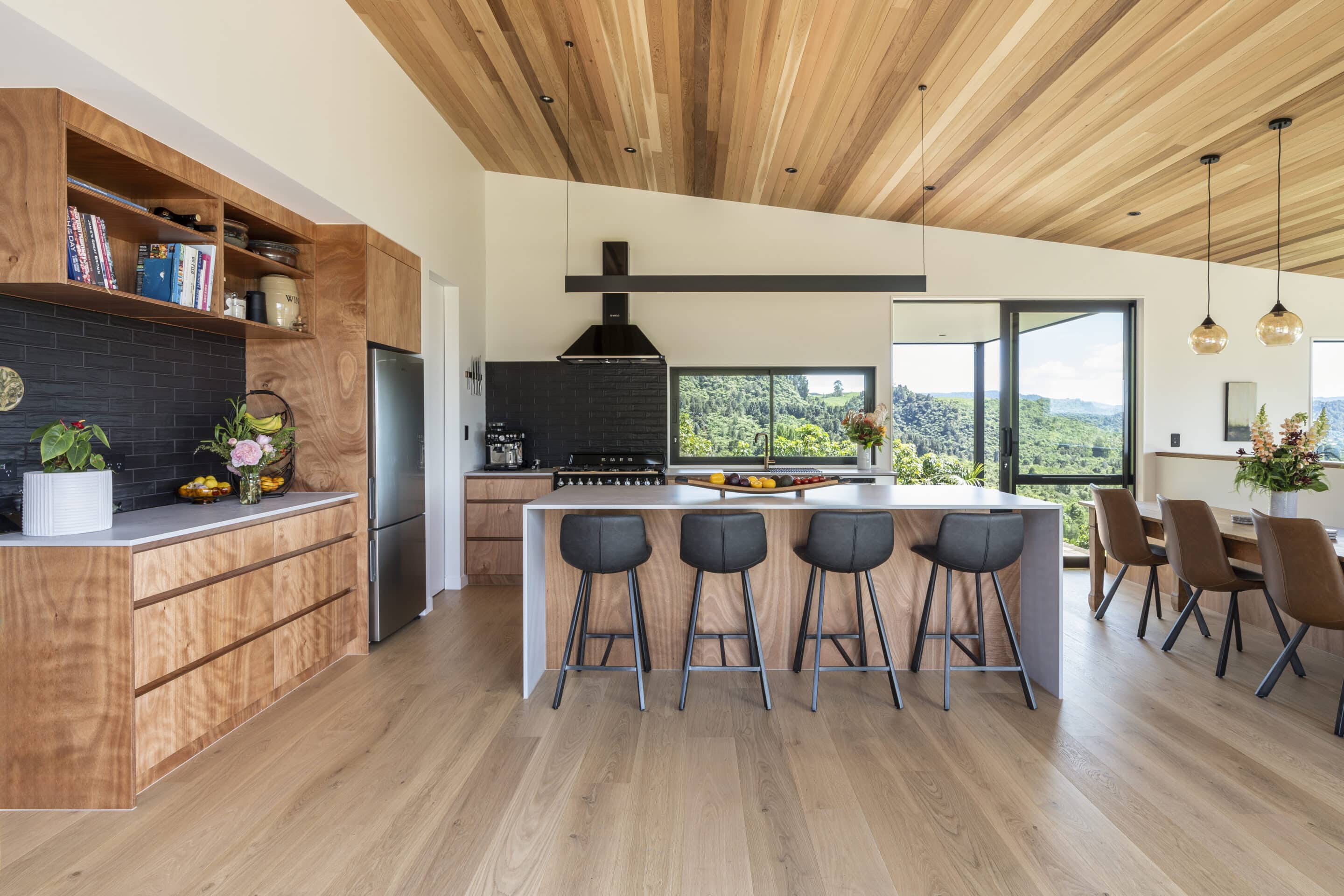 White oak hardwood flooring in open plan living dining with timber ceilings and a view