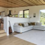 White oak hardwood flooring in open plan living dining with timber ceilings and a view